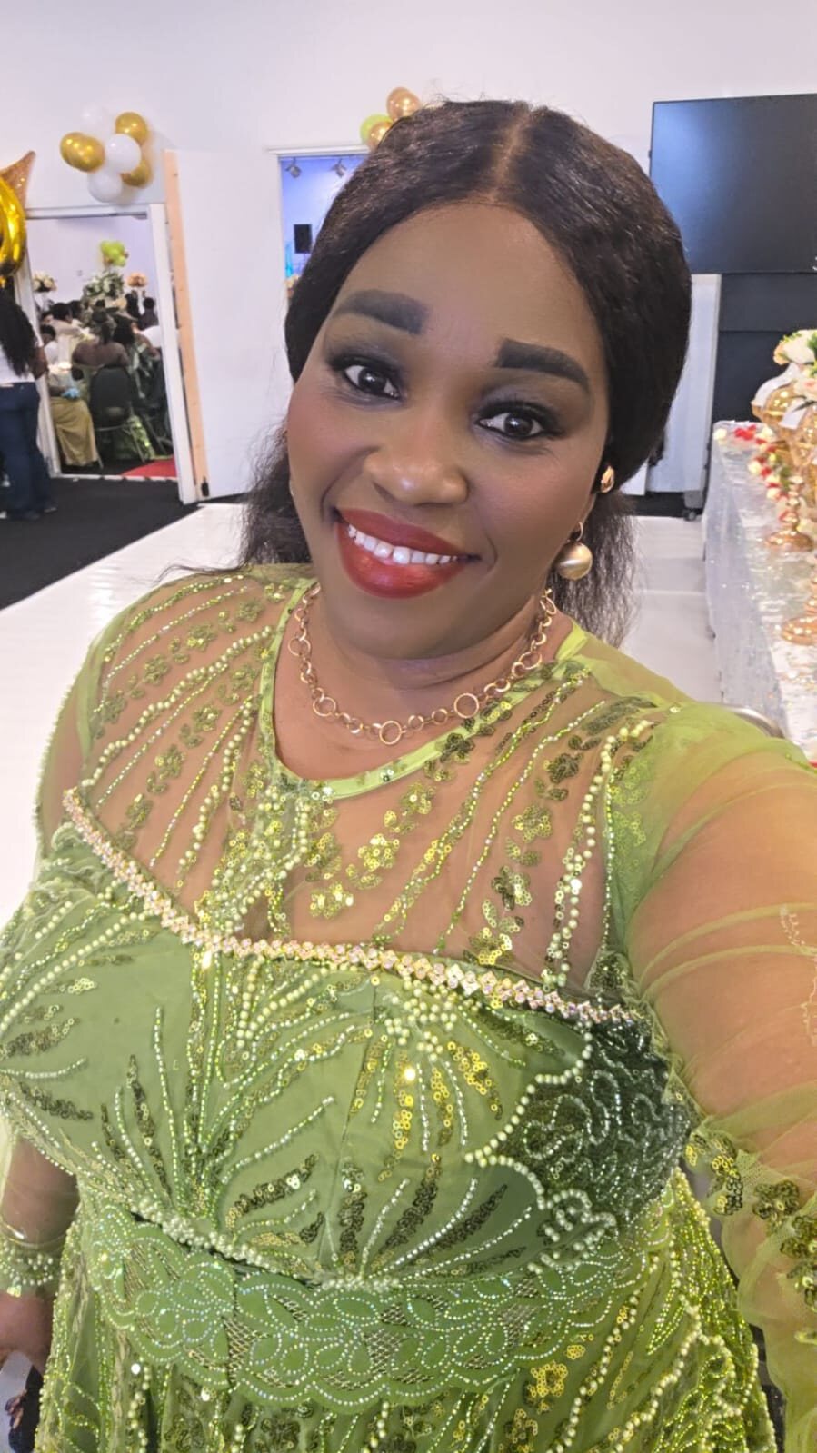 Stella Ijeoma Ahaiwe, known as StellyStar the Affiliate Coach, wearing a green formal dress